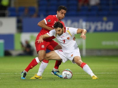 02.09.11 - Wales v Montenegro, Euro 2012 Qualifying -  Wales' Neil Taylor tangles with Montenegro's Simon Vukcevic  