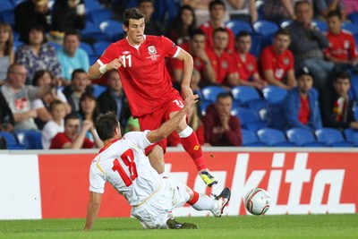 02.09.11 - Wales v Montenegro, Euro 2012 Qualifying -  Wales' Gareth Bale is tackled by Montenegro's Nikola Drincic   