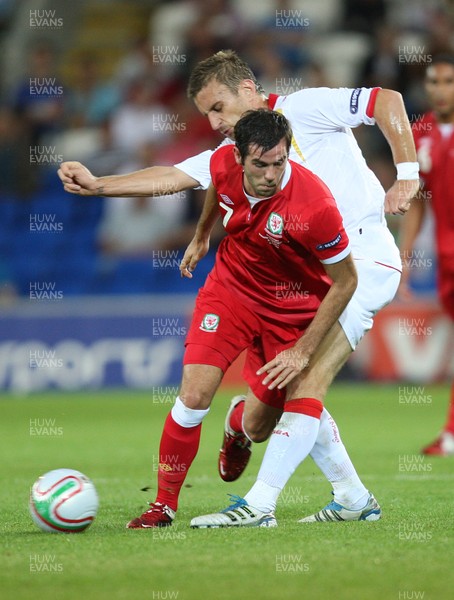 02.09.11 - Wales v Montenegro, Euro 2012 Qualifying -  Wales' Joe Ledley is challenged by Montenegro's Milorad Pekovic      