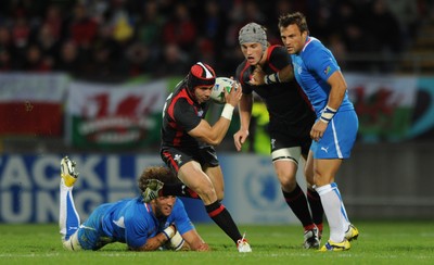 26.09.11 - Wales v Namibia - Rugby World Cup 2011 - Leigh Halfpenny of Wales gets past Jacques Burger of Namibia. 