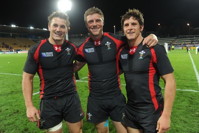 26.09.11 - Wales v Namibia - Rugby World Cup 2011 - Jonathan Davies, Rhyd Priestland and Lloyd Williams of Wales celebrate at the end of the game. 