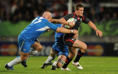 26.09.11 - Wales v Namibia - Rugby World Cup 2011 - Tavis Knoyle of Wales is tackled by Raoul Larson of Namibia. 