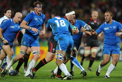 26.09.11 - Wales v Namibia - Rugby World Cup 2011 - Ryan Bevington of Wales is tackled by Wacca Kazombiaze of Namibia. 