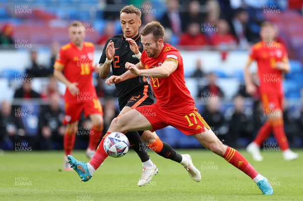 080622 - Wales v Netherlands, UEFA Nations League - Rhys Norrington-Davies of Wales is tackled by Noa Lang of Netherlands