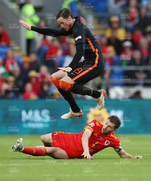 080622 - Wales v Netherlands, UEFA Nations League - Wout Weghorst of Netherlands is tackled by Ben Davies of Wales