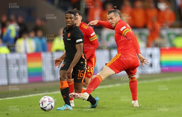 080622 - Wales v Netherlands, UEFA Nations League - Tyrell Malacia of Netherlands is challenged by Gareth Bale of Wales