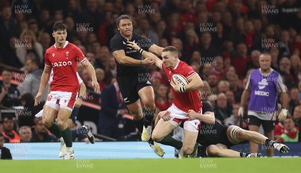 051122 - Wales v New Zealand, Autumn Nations Series - George North of Wales hands off Caleb Clarke of New Zealand as Scott Barrett of New Zealand  tackles
