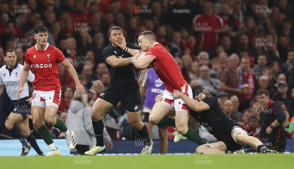 051122 - Wales v New Zealand, Autumn Nations Series - George North of Wales hands off Caleb Clarke of New Zealand as Scott Barrett of New Zealand  tackles