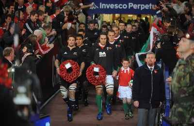 07.11.09 - Wales v New Zealand - Invesco Perpetual Series 2009 - All Blacks captain Richie McCaw and Wales captain Ryan Jones with mascot Jack Egan lead out their teams. 