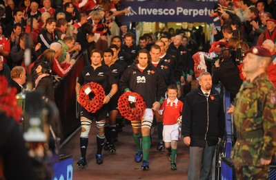 07.11.09 - Wales v New Zealand - Invesco Perpetual Series 2009 - All Blacks captain Richie McCaw and Wales captain Ryan Jones with mascot Jack Egan lead out their teams. 