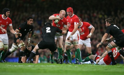 07.11.09  Wales v New Zealand... Wales Martyn Williams is held by Andrew Hore. 