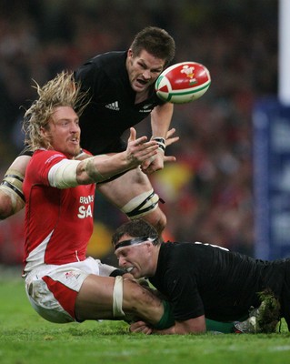 07.11.09  Wales v New Zealand... Wales  Andy Powell is tackled by Brad Thorn and Richie McCaw . 
