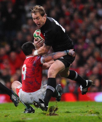 07.11.09 - Invesco Perpetual international Rugby, Wales v New Zealand Jimmy Cowan of New Zealand is tackled by Wales' Gareth Cooper 