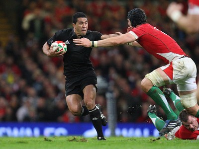 07.11.09... Wales v New Zealand, Invesco Perpetual Series New Zealands Mils Muliaina is tackled by Luke Charteris 
