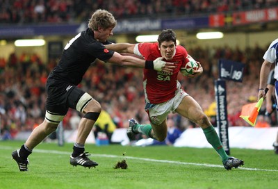 07.11.09... Wales v New Zealand, Invesco Perpetual Series Wales' James Hook is tackled by Adam Thomson 