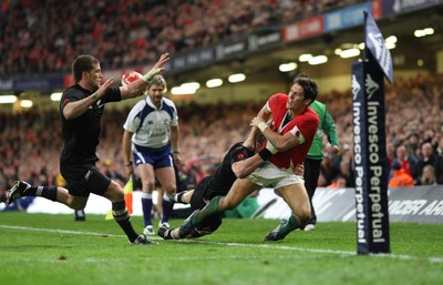 07.11.09... Wales v New Zealand, Invesco Perpetual Series Wales' James Hook is tackled by Adam Thomson 