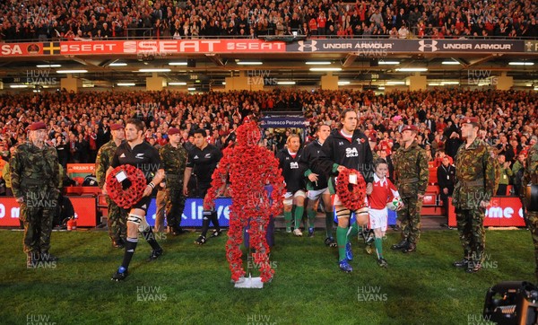 07.11.09 - Wales v New Zealand - Invesco Perpetual Series 2009 - All Blacks captain Richie McCaw and Wales captain Ryan Jones with mascot Jack Egan lead out their teams. 