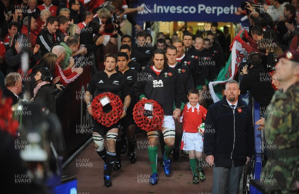07.11.09 - Wales v New Zealand - Invesco Perpetual Series 2009 - All Blacks captain Richie McCaw and Wales captain Ryan Jones with mascot Jack Egan lead out their teams. 