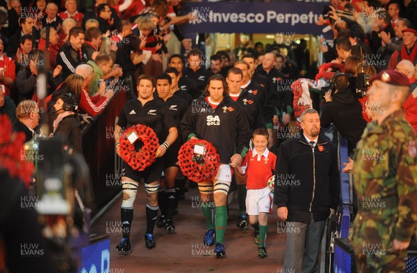 07.11.09 - Wales v New Zealand - Invesco Perpetual Series 2009 - All Blacks captain Richie McCaw and Wales captain Ryan Jones with mascot Jack Egan lead out their teams. 