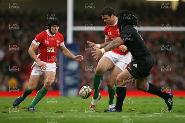 07.11.09  Wales v New Zealand... Wales Jamie Roberts kicks past Ma'a Nonu. 