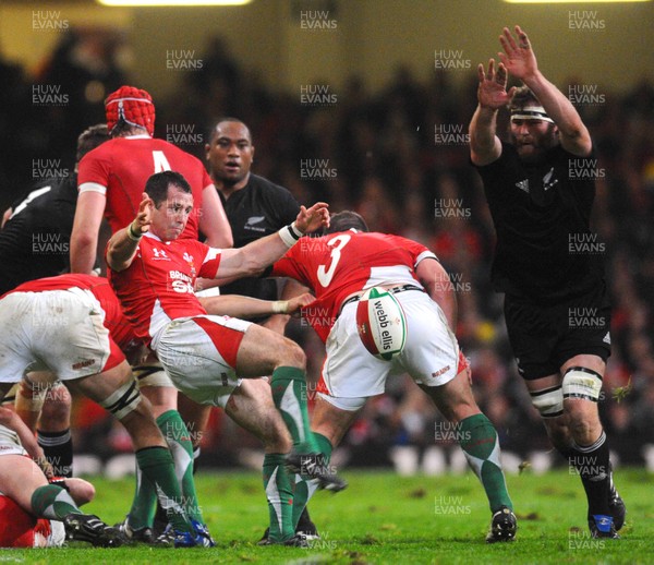 07.11.09 - Invesco Perpetual international Rugby, Wales v New Zealand Wales' Gareth Cooper kicks as Jason Eaton of New Zealand challenges 