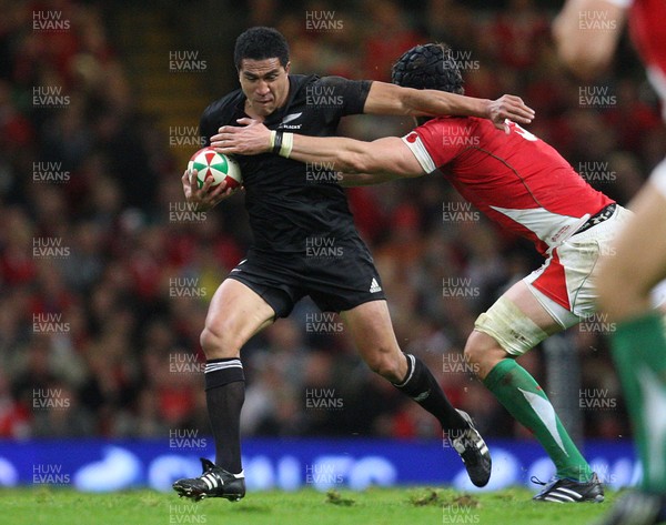 07.11.09... Wales v New Zealand, Invesco Perpetual Series New Zealands Mils Muliaina is tackled by Luke Charteris 
