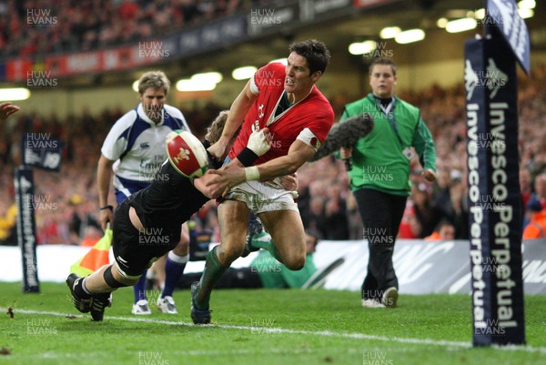 07.11.09... Wales v New Zealand, Invesco Perpetual Series Wales' James Hook is tackled by Adam Thomson 