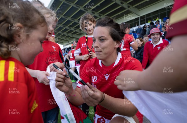161022 - Wales v New Zealand, Women’s Rugby World Cup 2021, Pool A - Sioned Harries of Wales signs autographs for young  supporters at the end of the match