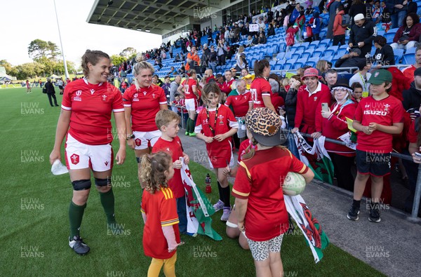 161022 - Wales v New Zealand, Women’s Rugby World Cup 2021, Pool A - Natalia John of Wales and Alex Callender of Wales with young  supporters at the end of the match