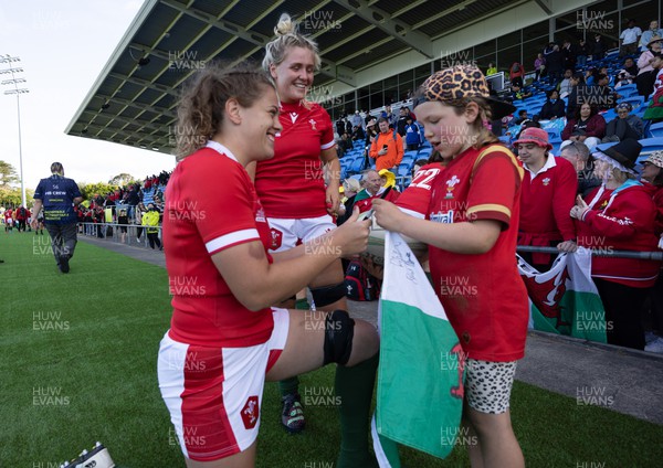 161022 - Wales v New Zealand, Women’s Rugby World Cup 2021, Pool A - Natalia John of Wales and Alex Callender of Wales sign autographs for young  supporters at the end of the match