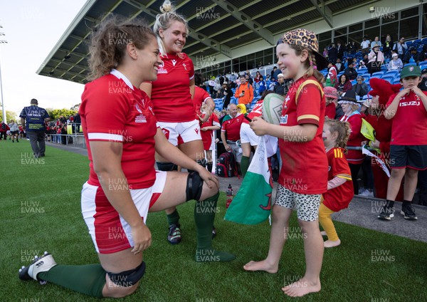 161022 - Wales v New Zealand, Women’s Rugby World Cup 2021, Pool A - Natalia John of Wales and Alex Callender of Wales sign autographs for young  supporters at the end of the match