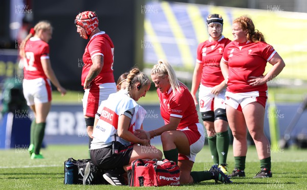 161022 - Wales v New Zealand, Women’s Rugby World Cup 2021, Pool A - Kelsey Jones of Wales receives treatment from Jo Perkins