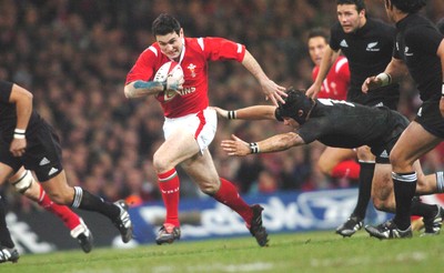 20-11-04. Wales v New Zealand   Wales' Stephen Jones gets away from Ritchie Macaw.  