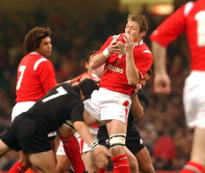 20.11.04 - Wales v New Zealand Wales' Dafydd Jones takes as Richie McCaw tackles  