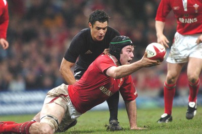 20-11-04. Wales v New Zealand   Wales' Michael Owen offloads ball as Daniel Carter tackles.  