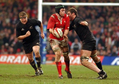20.11.04  Wales v New Zealand, Cardiff  Michael Owen is tackled by Chris Jack  