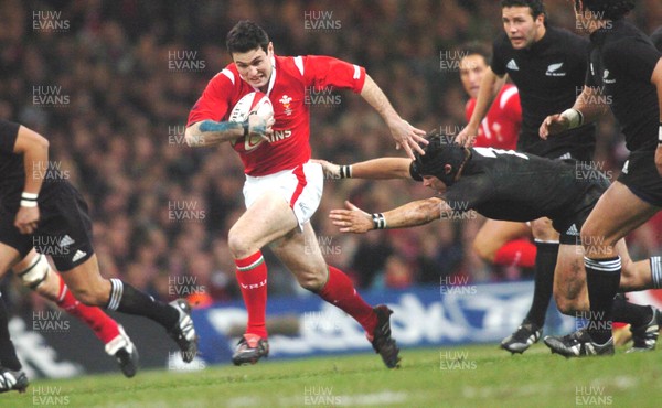 20-11-04. Wales v New Zealand   Wales' Stephen Jones gets away from Ritchie Macaw.  