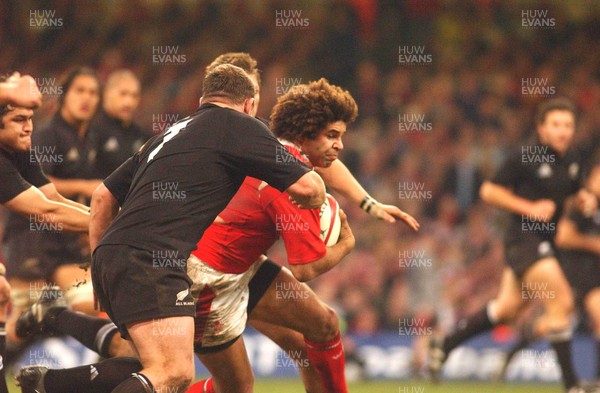 20.11.04  Wales v New Zealand, Cardiff  Wales Colin Charvis is tackled by Tony Woodcock  
