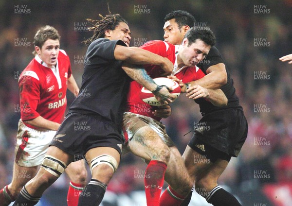 20-11-04. Wales v New Zealand   Wales' Stephen Jones is caught as he tries to break through.  