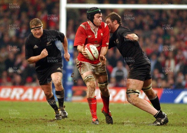 20.11.04  Wales v New Zealand, Cardiff  Michael Owen is tackled by Chris Jack  