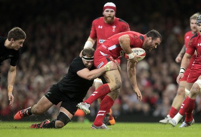 221114 - Wales v New Zealand - Dove Men Series 2014 - Jamie Roberts of Wales is tackled by Wyatt Crockett of New Zealand