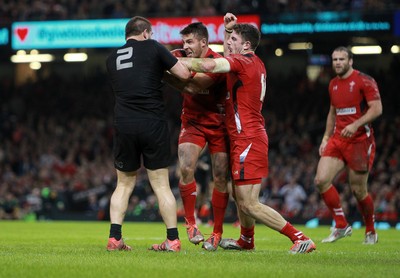 221114 - Wales v New Zealand - Dove Men Series 2014 - Dane Coles of New Zealand and Rhys Webb with Alex Cuthbert of Wales exchange blows