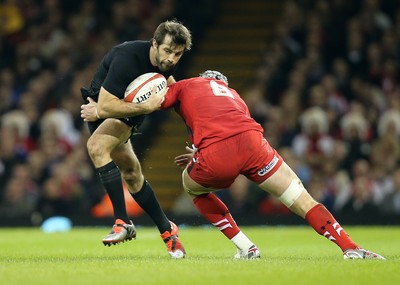 221114 -  Wales v New Zealand, Dove Men Series 2014, Cardiff - Conrad Smith of New Zealand is tackled by Dan Lydiate of Wales 