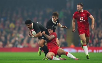 221125 - Wales v New Zealand, Quilter Nations Series - Caleb Clarke of New Zealand is tackled by Louis Rees-Zammit of Wales