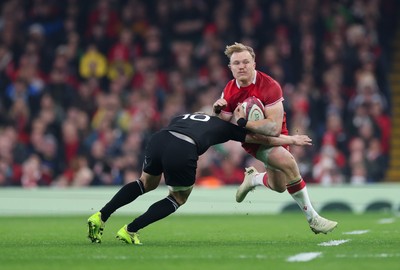 221125 - Wales v New Zealand, Quilter Nations Series -Blair Murray of Wales takes on Damian McKenzie of New Zealand  