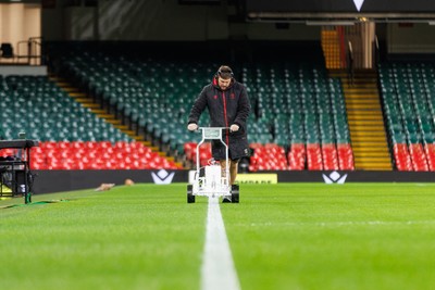 221125 - Wales v New Zealand - Quilter Nations Series - Groundsman marks lines on the Principality Stadium pitch before the match