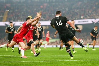 221125 - Wales v New Zealand - Quilter Nations Series - Will Jordan of New Zealand kicks the ball under pressure from Tomos Williams of Wales