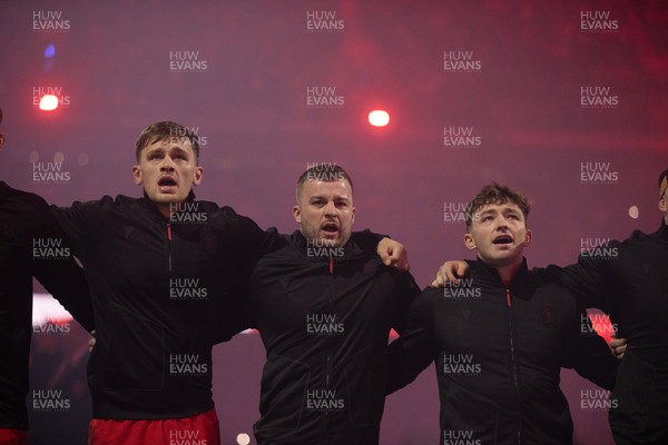 221125 - Wales v New Zealand All Blacks - Quilter Nations Series - Alex Mann, Harri Deaves and Dan Edwards of Wales during the anthem