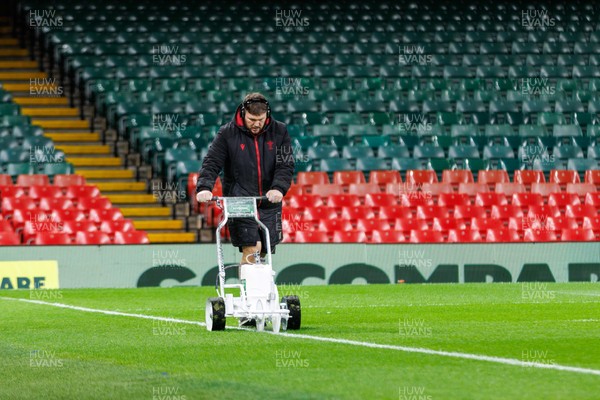221125 - Wales v New Zealand - Quilter Nations Series - Groundsman marks lines on the Principality Stadium pitch before the match