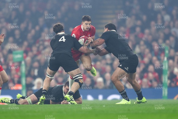 221125 - Wales v New Zealand - Quilter Nations Series - Joe Hawkins of Wales is tackled by Scott Barrett and Tamaiti Williams of New Zealand